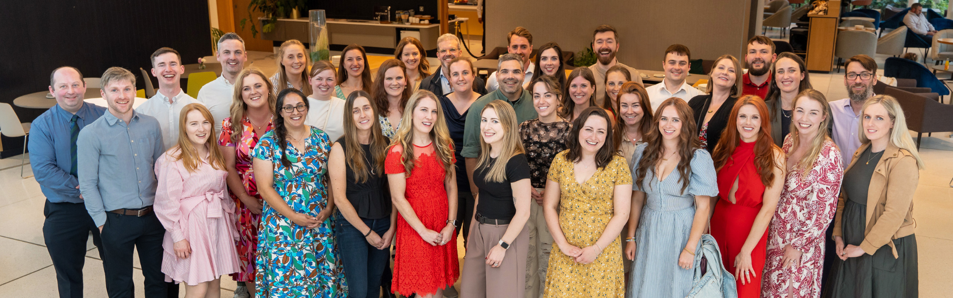 A group of ucd alumni smiling at a reunion event